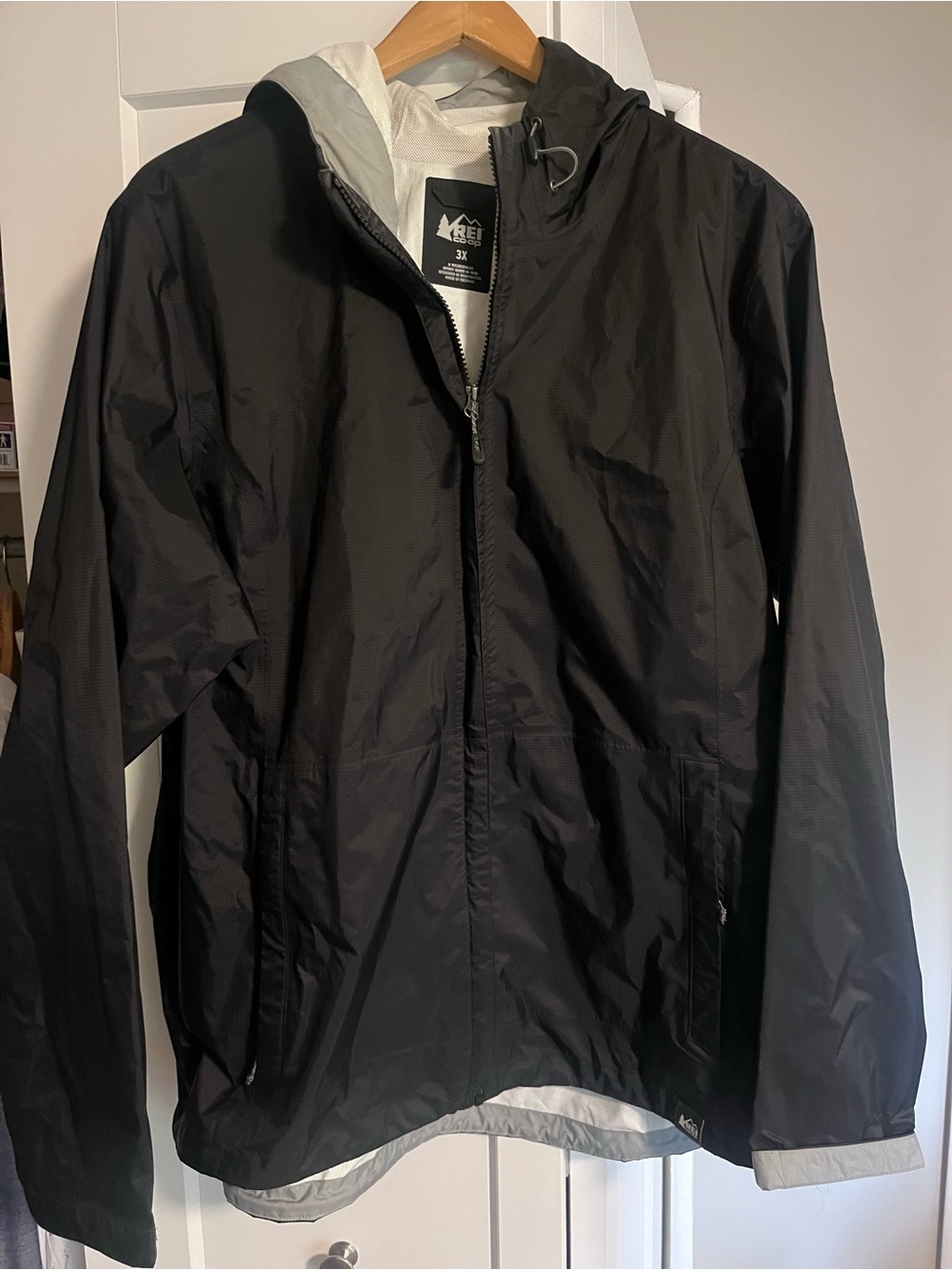 Like new REI Black Hooded Lightweight Rain Shell with Gray Lining